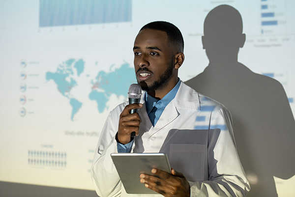 A black medical professional gives a presentation.