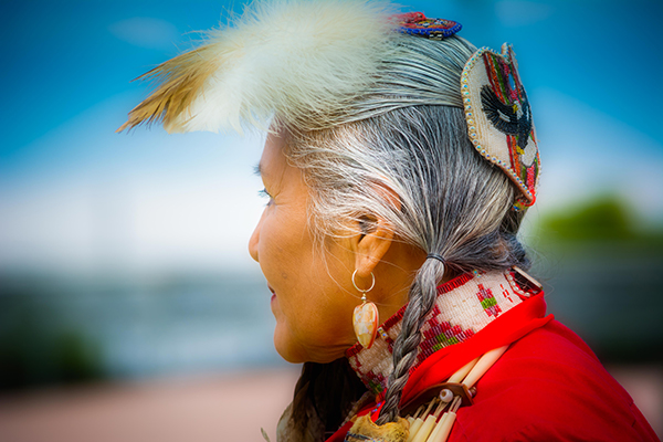 Closeup of Native American elder woman in traditional garb looking at the landscape