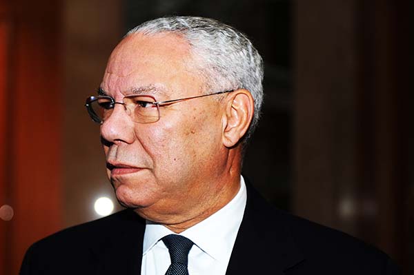 Closeup headshot of Colin Powell wearing a suit and looking off to the side