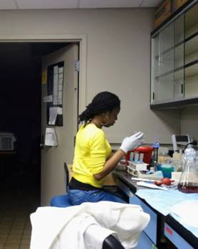 Dr. Olufemi performs her experiments while seated at a counter in the lab during graduate school.