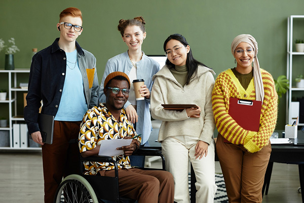 a diverse group of disabled young adults in a modern office