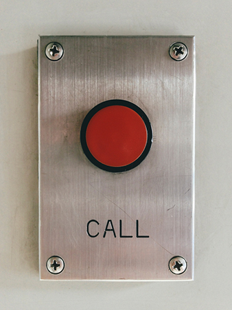 Red call button on the wall.