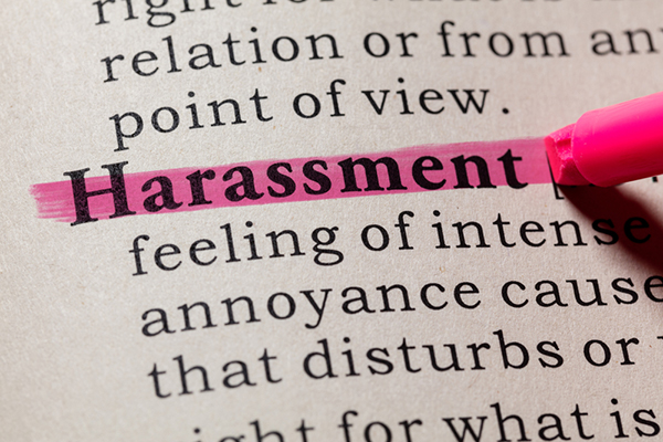 Harassment highlighted in pink with incomplete text of its definition. 