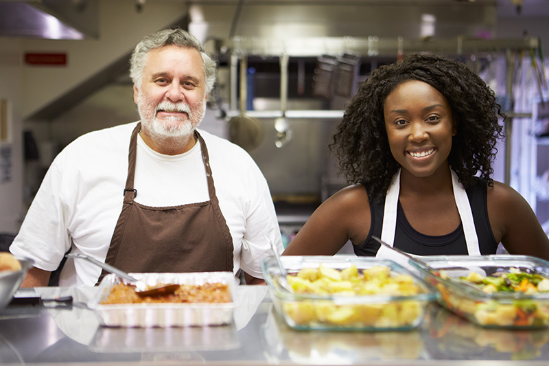 Photo of two volunteers at a food kitchen