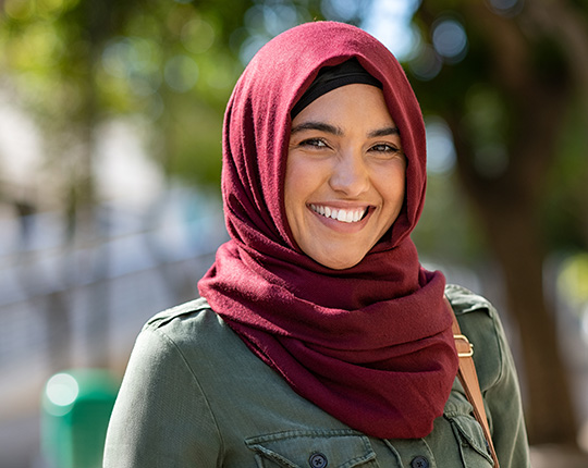 A Muslim woman smiling.