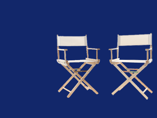 Two director-style cloth and wooden chairs facing one another, against a blue background.