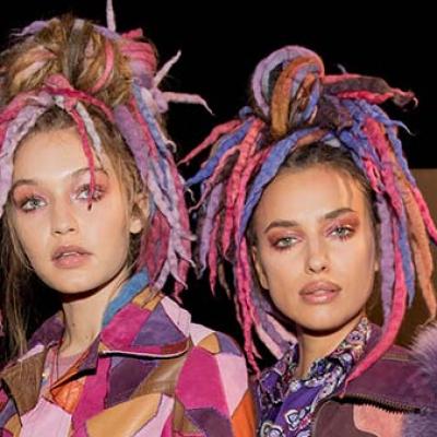 Photograph of two female models who appear to be Caucasian with colorful dread-locked hair