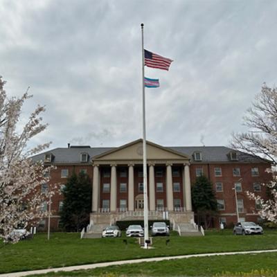The United States and Transgender Pride flag flying in front of Building 1, the main building of NIH.