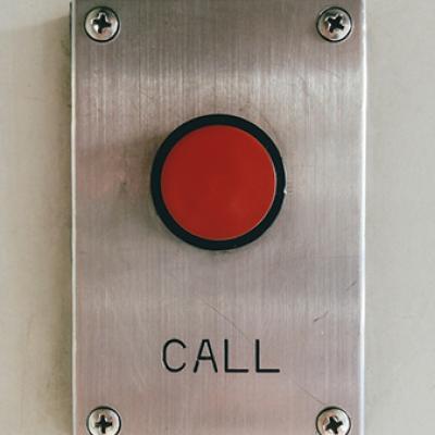 Red call button on the wall.