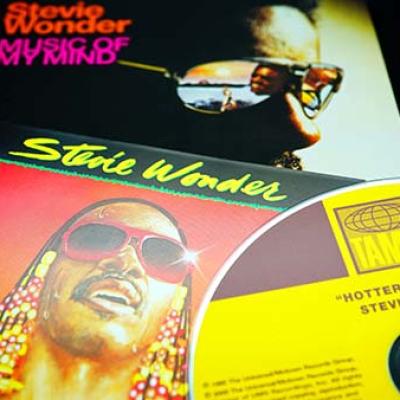Closeup of Stevie Wonder’s Hotter Than July album cover and CD with Music of My mind album cover in background